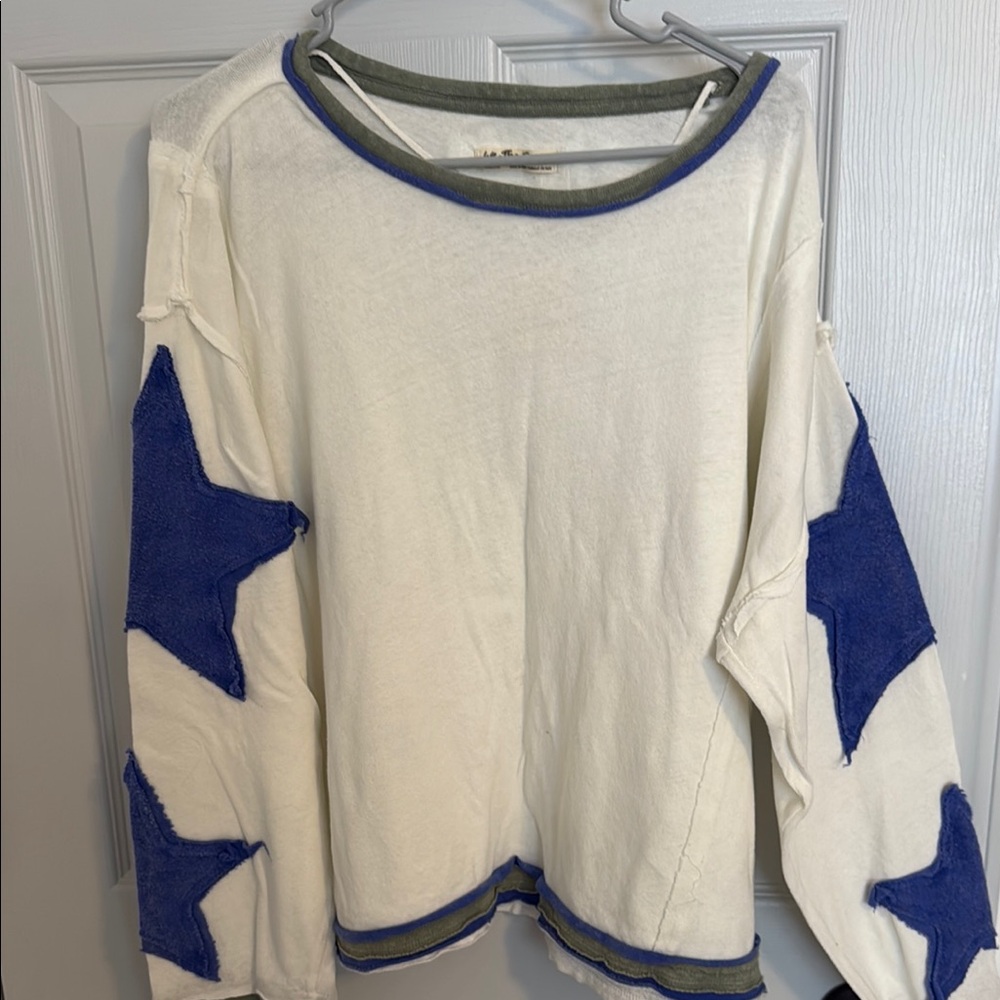 White Sweater with Blue Star Accents